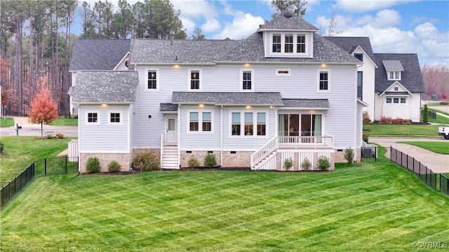 rear view of property featuring a lawn and cooling unit