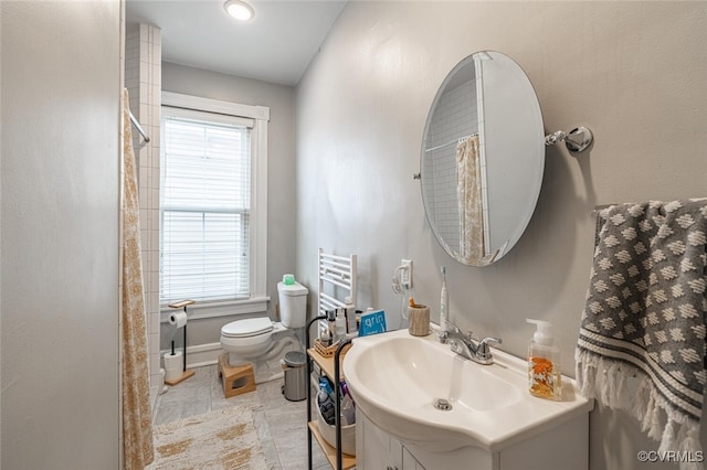 bathroom featuring tile patterned floors, vanity, and toilet