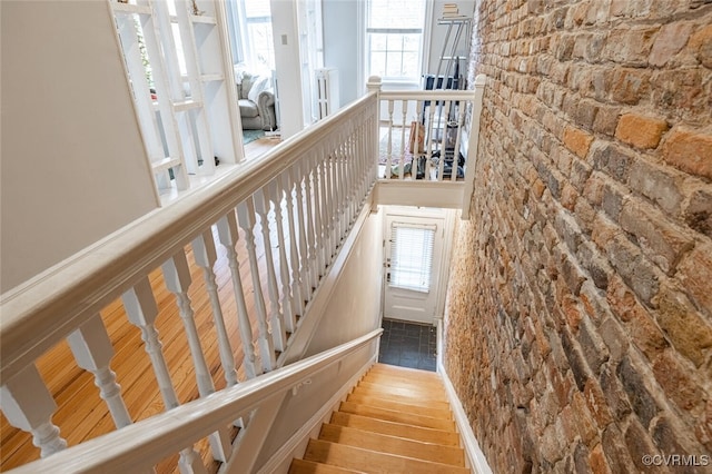 stairs featuring hardwood / wood-style floors