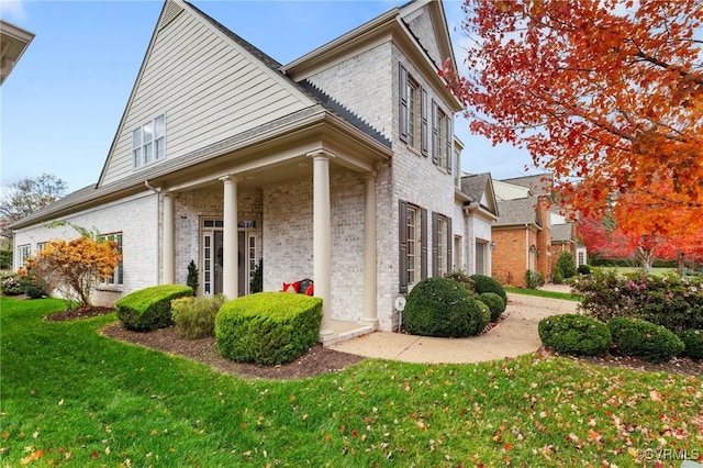 view of side of home featuring a yard