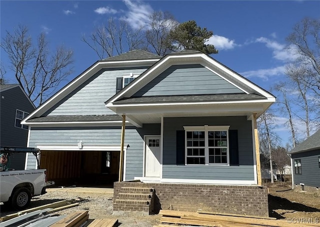 view of front facade featuring a garage, a porch, and roof with shingles