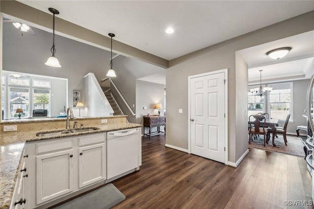 kitchen with dishwasher, white cabinets, pendant lighting, and dark hardwood / wood-style floors