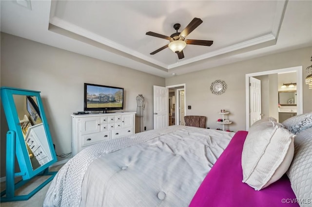 carpeted bedroom featuring ceiling fan and a raised ceiling