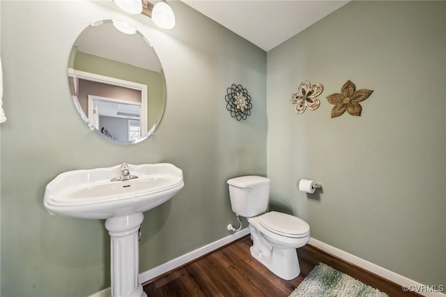 bathroom with wood-type flooring and toilet