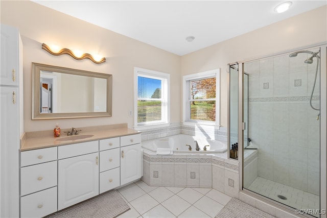 bathroom featuring tile patterned flooring, vanity, and shower with separate bathtub