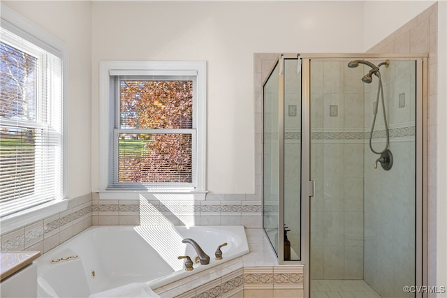 bathroom featuring shower with separate bathtub and a wealth of natural light