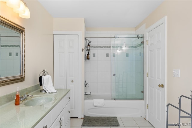 bathroom with tile patterned floors, vanity, and enclosed tub / shower combo