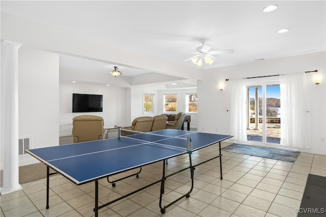 game room featuring decorative columns, ceiling fan, and light tile patterned flooring