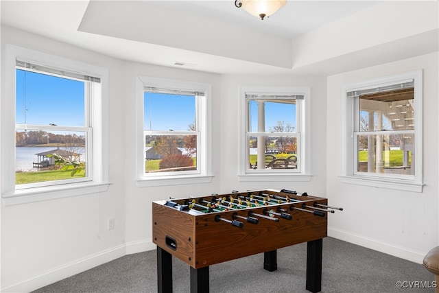 playroom with carpet, a water view, and a wealth of natural light