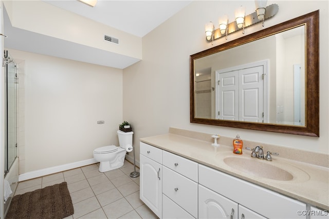 full bathroom featuring tile patterned flooring, vanity, toilet, and combined bath / shower with glass door