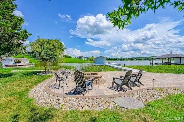 view of patio featuring a gazebo, a water view, and a fire pit