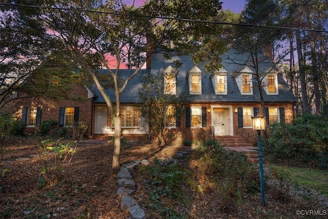 cape cod house with brick siding