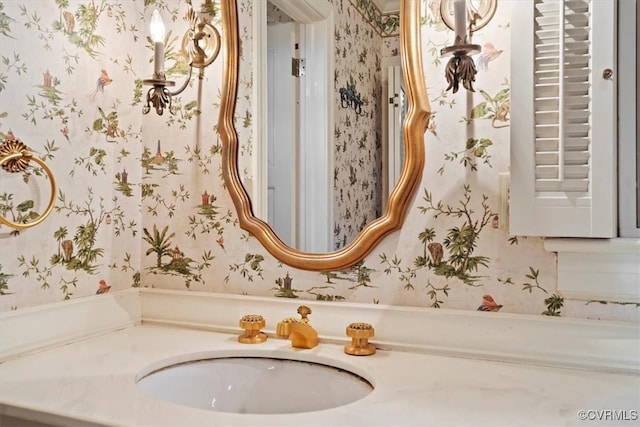 bathroom with wallpapered walls and vanity