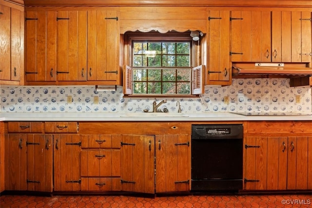 kitchen with black dishwasher, decorative backsplash, light countertops, and a sink