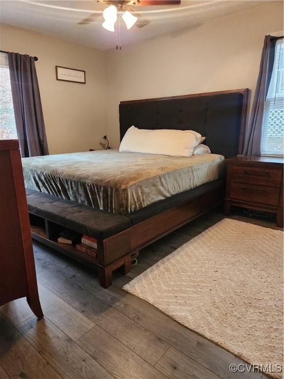 bedroom featuring ceiling fan and dark hardwood / wood-style flooring