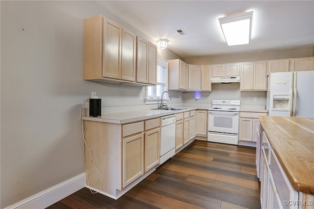 kitchen featuring light countertops, white appliances, a sink, and under cabinet range hood