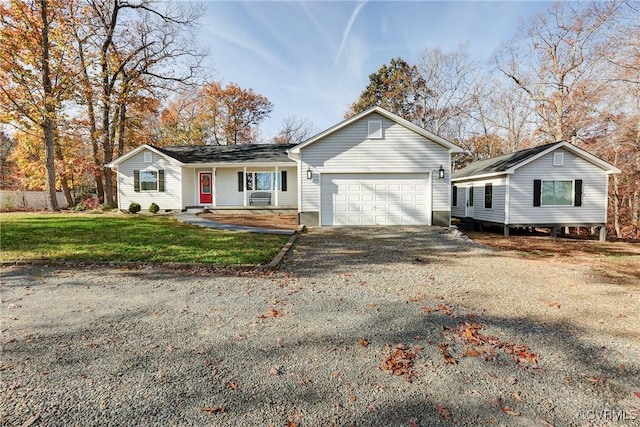 ranch-style home with driveway, an attached garage, and a front lawn