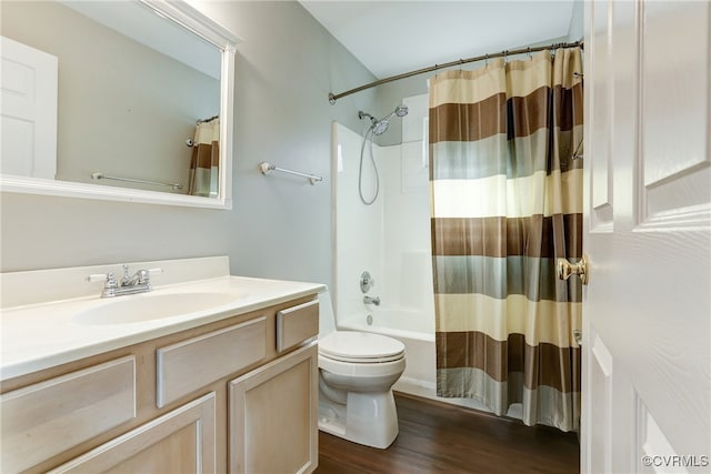 bathroom featuring toilet, shower / tub combo, wood finished floors, and vanity