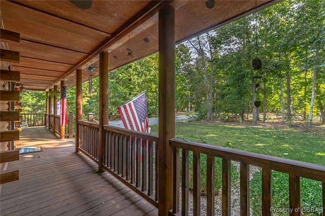 wooden deck with a yard and a porch