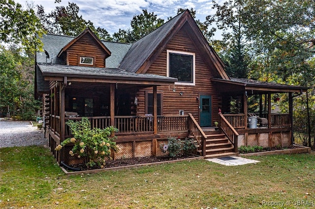 view of front of home with covered porch and a front lawn