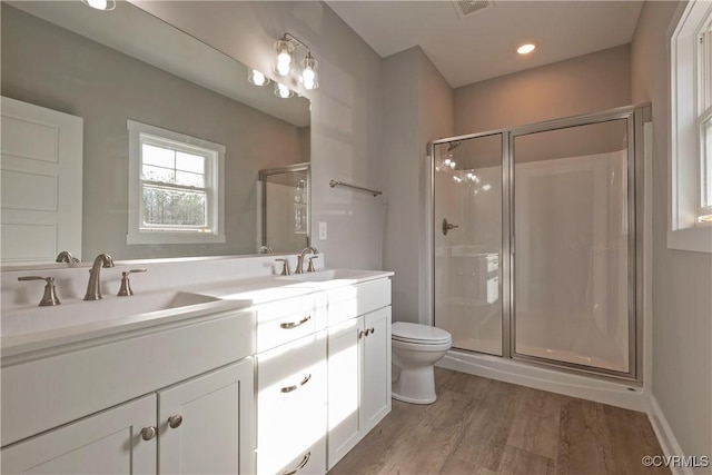 bathroom featuring vanity, a shower with shower door, toilet, and wood-type flooring