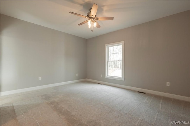 carpeted spare room with ceiling fan