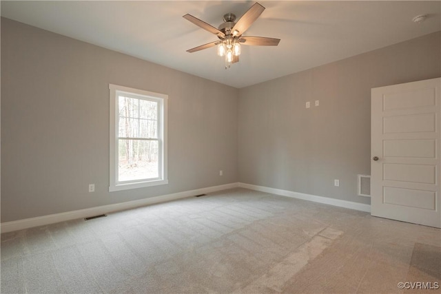 empty room featuring ceiling fan and light carpet