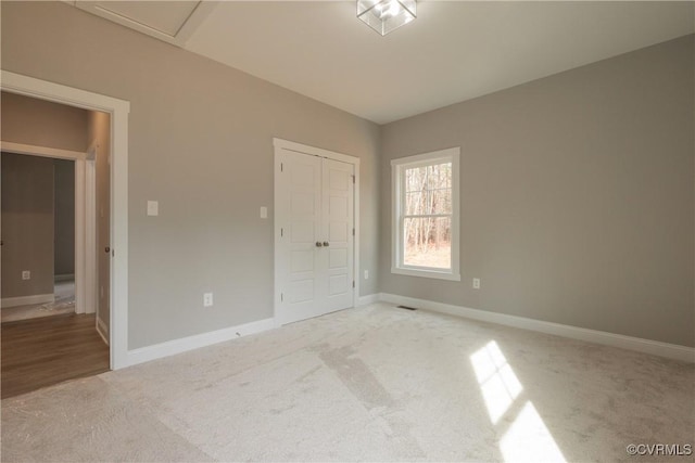 unfurnished bedroom featuring carpet floors and a closet