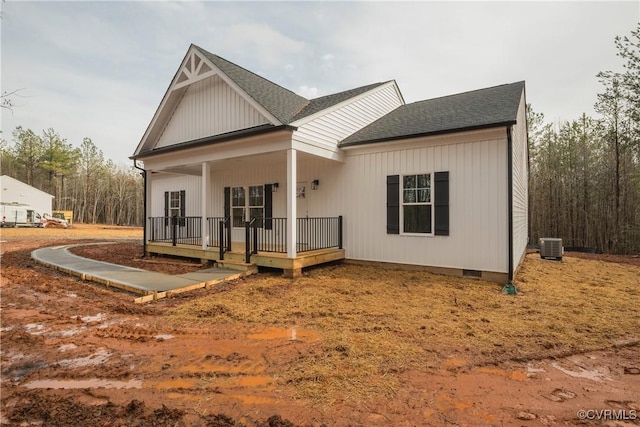 back of property featuring central AC unit and covered porch