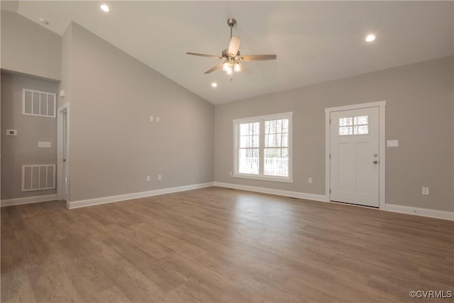 unfurnished living room with hardwood / wood-style flooring, high vaulted ceiling, and ceiling fan