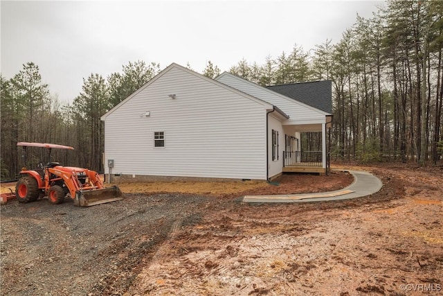 view of property exterior featuring a porch