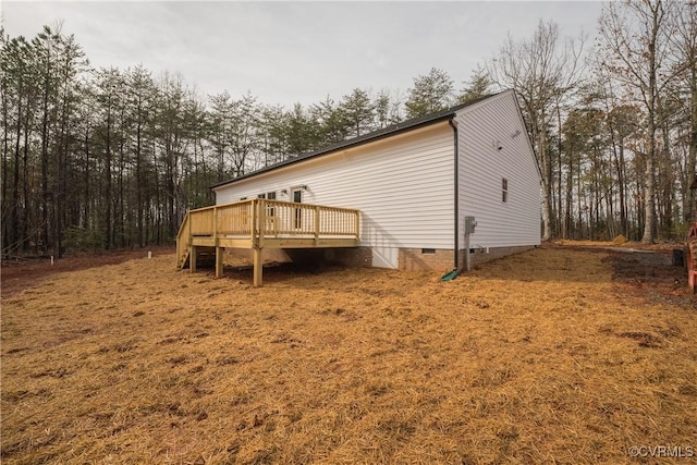 view of side of property featuring a wooden deck