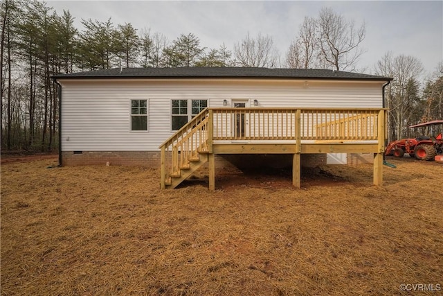 rear view of property with a wooden deck