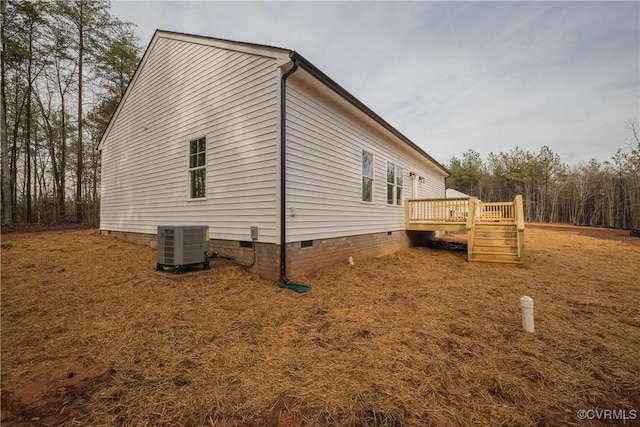 view of side of property featuring a wooden deck and central air condition unit