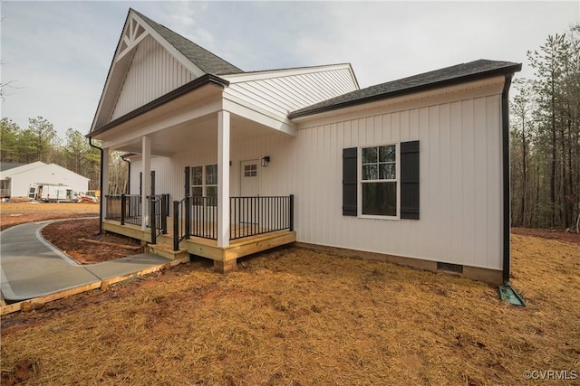 rear view of property with covered porch