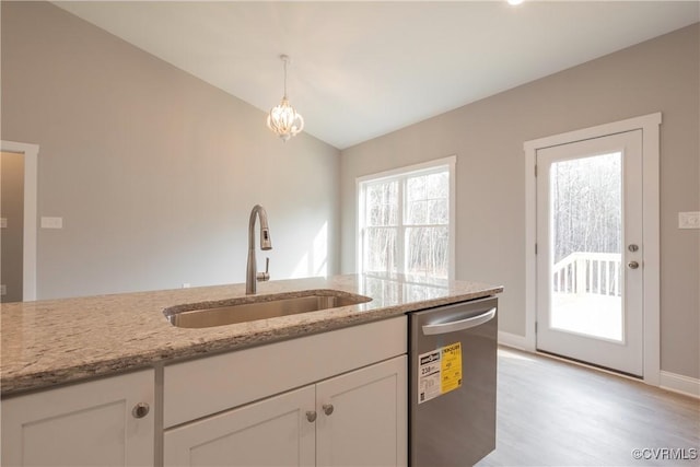 kitchen featuring lofted ceiling, sink, dishwasher, light stone countertops, and white cabinets