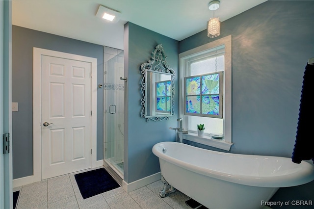 bathroom with tile patterned floors and separate shower and tub