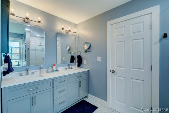 bathroom with vanity, tile patterned floors, and a shower with shower door