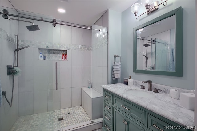 bathroom with vanity and a shower with door