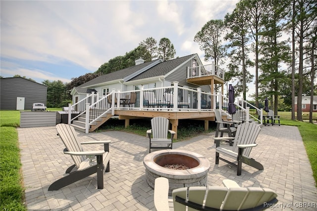 back of house featuring an outdoor fire pit, a patio area, and a wooden deck