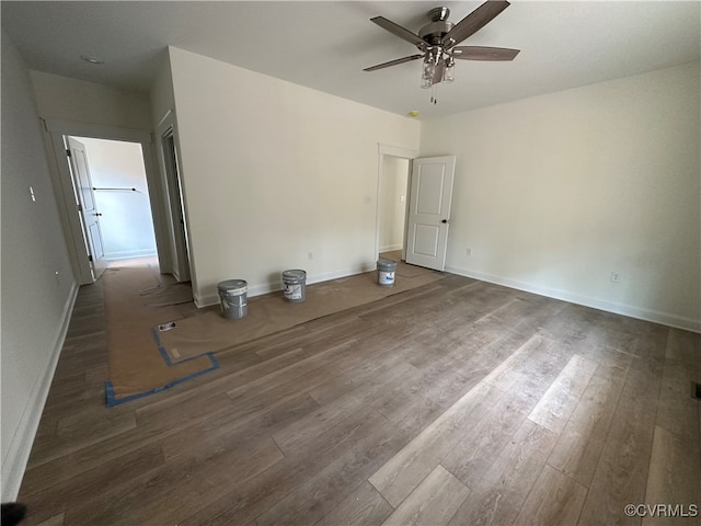 interior space featuring ceiling fan and dark wood-type flooring