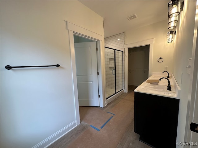 bathroom with vanity and an enclosed shower