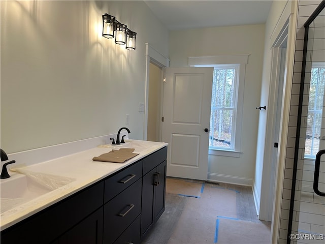 bathroom with a shower with door, vanity, and hardwood / wood-style flooring