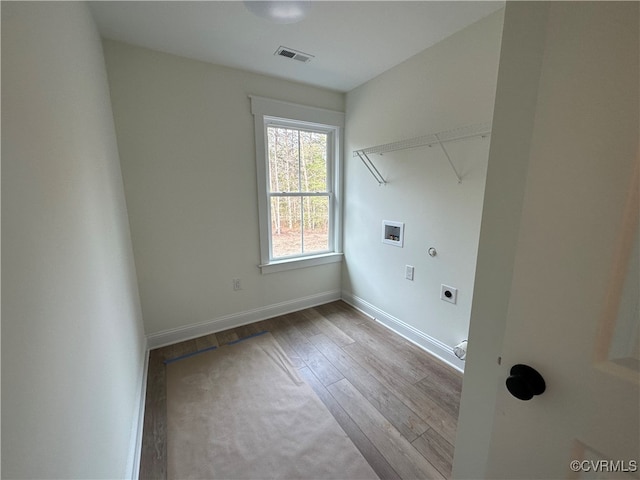 laundry area with hookup for an electric dryer, hardwood / wood-style flooring, and hookup for a washing machine