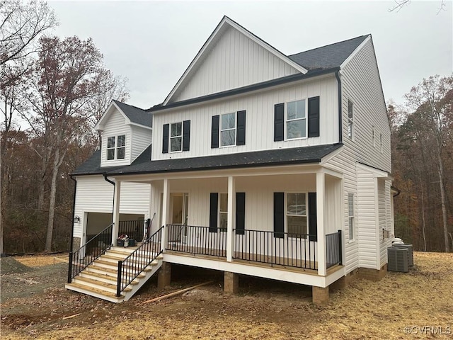 view of front of home featuring a porch, central AC, a shingled roof, stairs, and board and batten siding