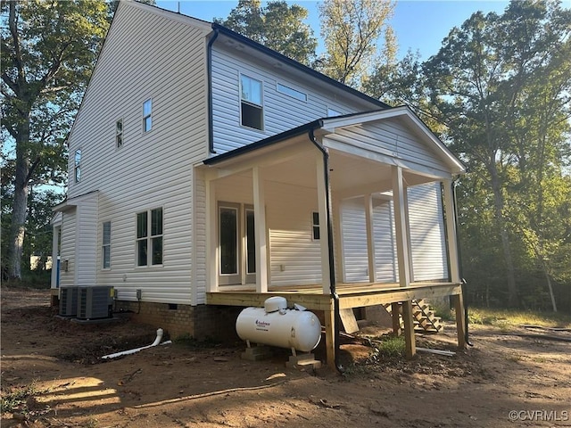 rear view of property with crawl space, central AC, and covered porch