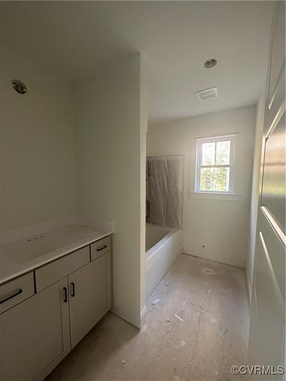 full bath featuring vanity, a bathing tub, and visible vents