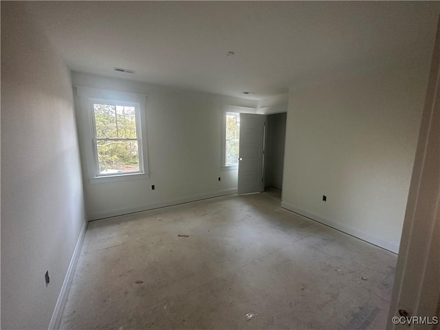 unfurnished room with baseboards and visible vents