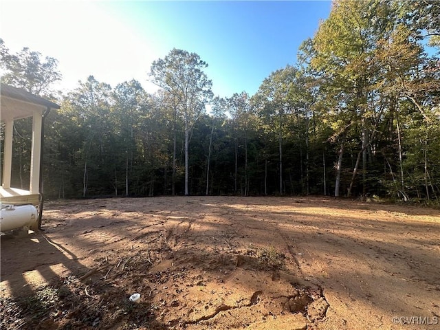 view of yard featuring a forest view