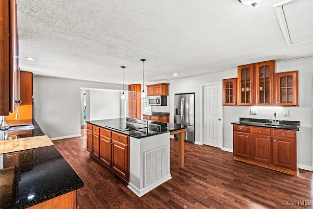 kitchen with pendant lighting, a center island, sink, dark hardwood / wood-style floors, and appliances with stainless steel finishes